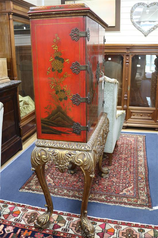 A red lacquer cocktail cabinet on stand, W.105cm